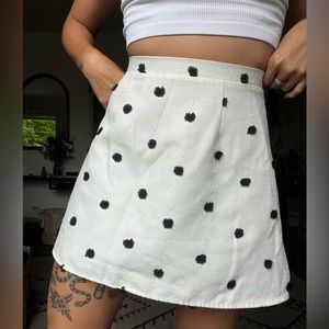 White Textured linen A Line skirt darted with black pompoms.